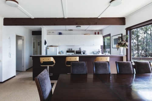 Kitchen and dining area of older style retro funky Australian beach house