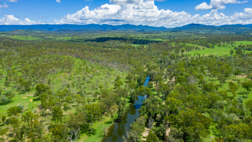 Kroombit Tops National Park summer landscape with freshwater creek and vibrant green vegetation - Australian Stock Image