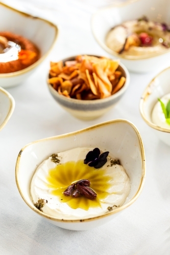 Labneh served in a small bowl on a white countertop. - Australian Stock Image