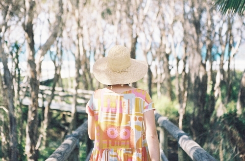 Lady in pastel walking toward the beach - Australian Stock Image