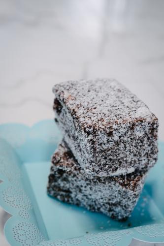 lamingtons on a blue plate - Australian Stock Image