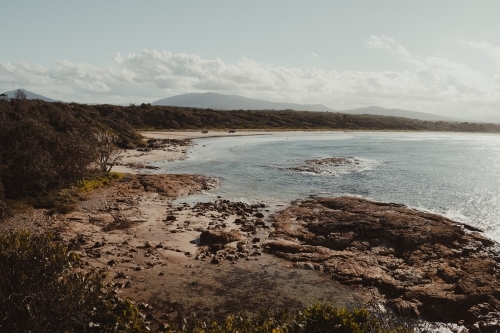 Landscape of the rocky coast and clear water at Diamond Head Beach, NSW. - Australian Stock Image