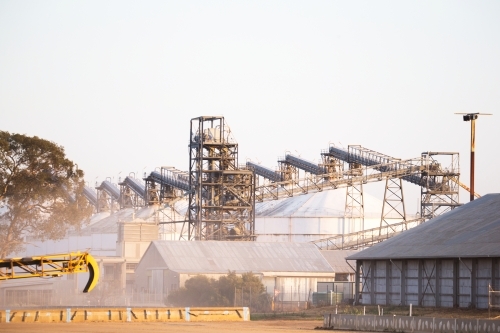 Landscape shot of a construction site with multiple steels and cranes with storage areas - Australian Stock Image
