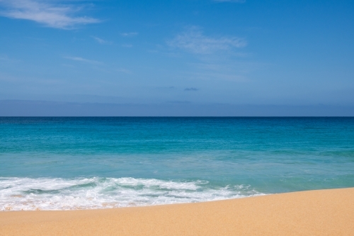 Landscape view of sand and ocean, and blue sky - Australian Stock Image