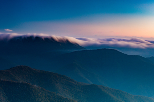 Landscape views of sunset from the summit of Mt Buller over the Victorian Alps in the Victorian High - Australian Stock Image