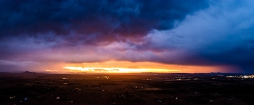 Landscape with dramatic storm clouds at sunset - Australian Stock Image
