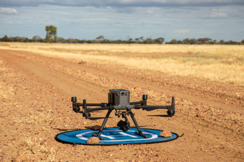 Large agricultural drone ready for takeoff on a landing mat - Australian Stock Image