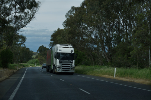 Large B-Double truck with car travelling behind - Australian Stock Image
