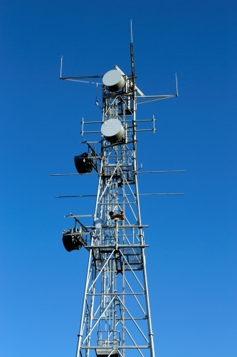 Large industrial telecommunication tower with blue sky behind - Australian Stock Image