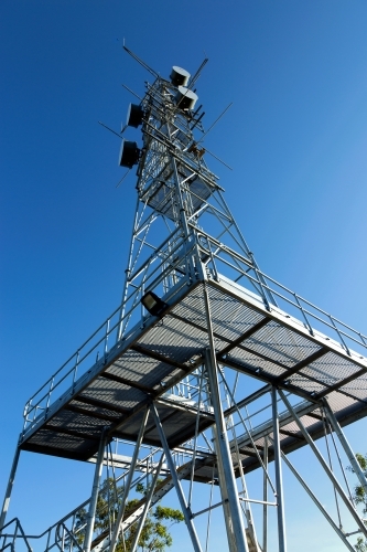 Large industrial telecommunication tower with blue sky behind - Australian Stock Image
