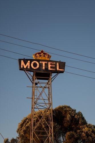 Large light-up 'MOTEL' sign against blue sky - Australian Stock Image