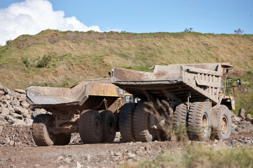 Large mining trucks parked at quarry - Australian Stock Image