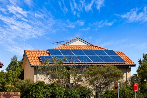 Large solar panels on suburban rooftop