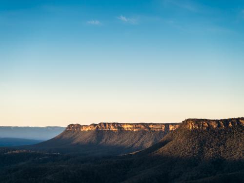 Last sun on hills of sandstone mesa formations in Cattai National Park - Australian Stock Image