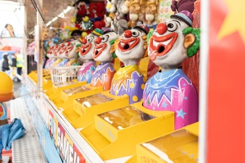Laughing clowns game attraction at a fair carnival - Australian Stock Image