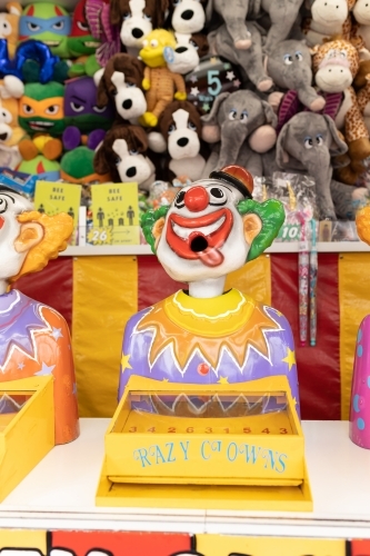 Laughing clowns game attraction at a fair carnival - Australian Stock Image