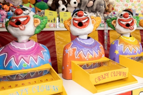 Laughing clowns game attraction at a fair carnival - Australian Stock Image