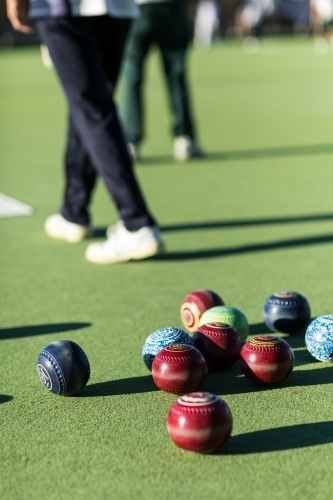 Lawn bowls on bowing green with bowlers behind - Australian Stock Image