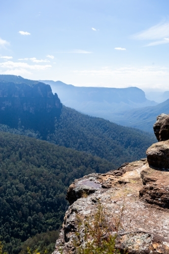 Layered mountains and valleys with rocks in foreground - Australian Stock Image