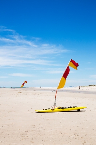 Life saver flags on the beach vertical - Australian Stock Image