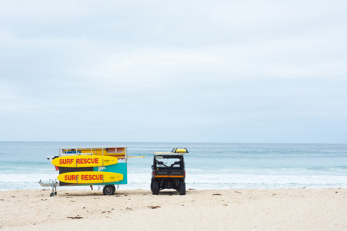Life saving buggy and boards on the beach - Australian Stock Image