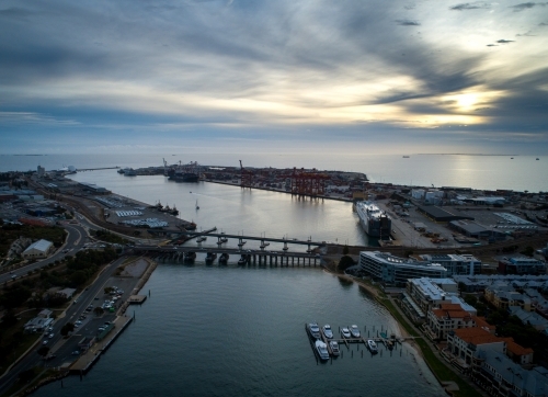 Light pierces cloud in an aerial view over a port