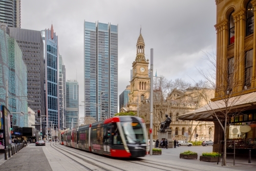 Light rail in front of Town Hall in Sydney on overcast day - Australian Stock Image