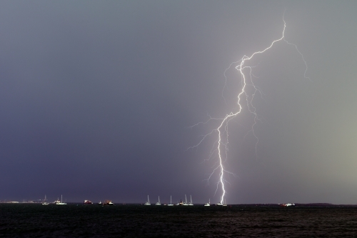 Lightning bolt over yachts in Darwin - Australian Stock Image