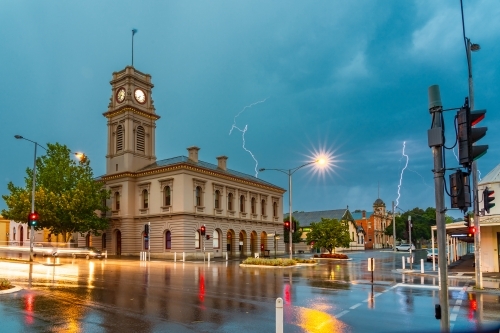 Lightning cracking over an historic Post Office at a country town intersection - Australian Stock Image