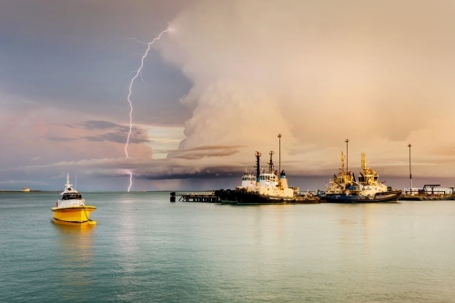 Lightning over Fort Hill Wharf and boats, in Darwin - Australian Stock Image