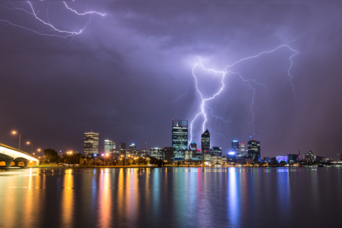Lightning Over Perth City And Swan River with lights reflected in water - Australian Stock Image
