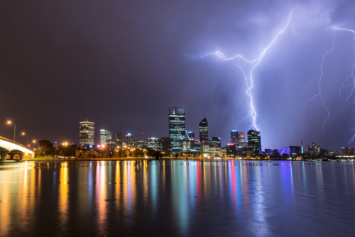 Lightning Over Perth City And Swan River with lights reflected in water - Australian Stock Image