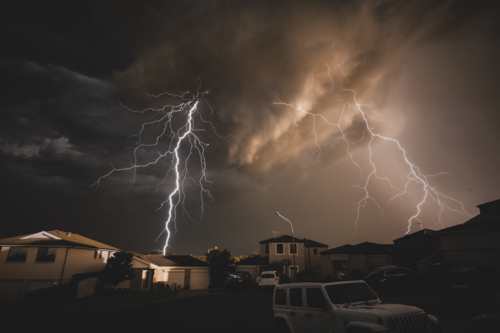 Lightning storm in Sydney suburbs in bad weather - Australian Stock Image
