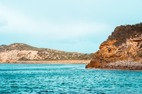 Limestone cliffs and rocks surrounded by water - Australian Stock Image