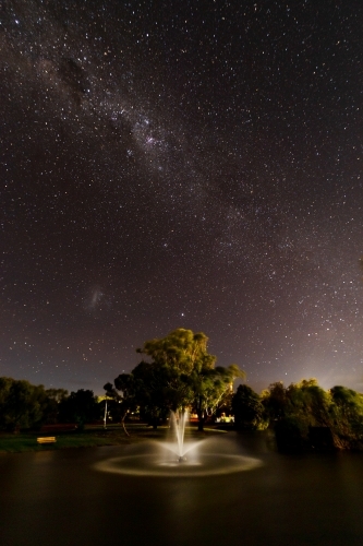 lit up fountain under starry sky - Australian Stock Image