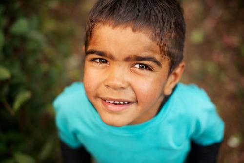 Little Aboriginal Boy Looking Upwards - Australian Stock Image