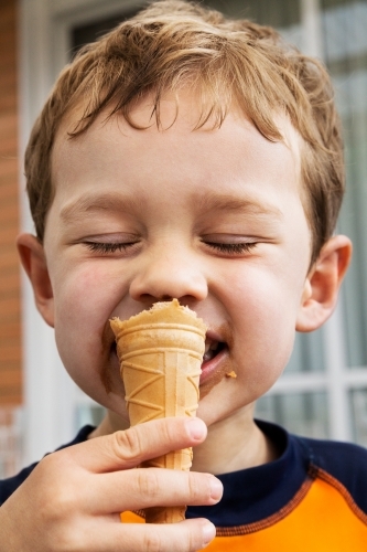 Little boy eating ice cream on a hot summer's day