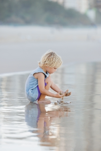 Little boy playing on the sand at Main Beach, Surfers Paradise on the Gold Coast - Australian Stock Image