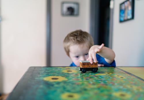 Little Boy playing with a Toy Train - Australian Stock Image