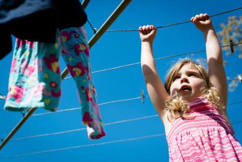 Little girl at the clothesline