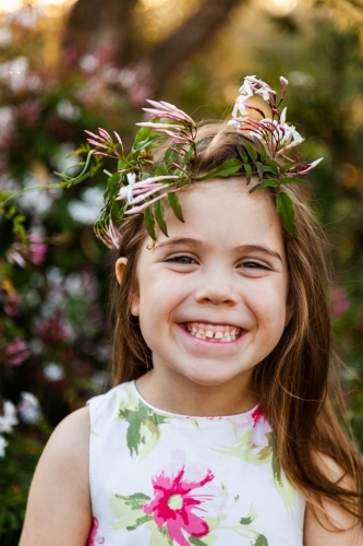Little girl in garden with jasmine flower crown - Australian Stock Image