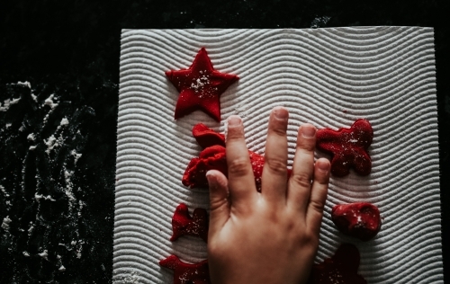 Little hands with red Christmas sweets