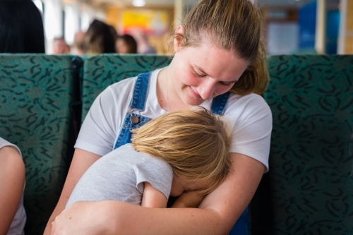 little kid sleeping on ferry - Australian Stock Image