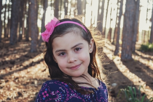 Little multicultural girl in the wood - Australian Stock Image