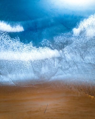Lone figure stranded on a beach - Australian Stock Image