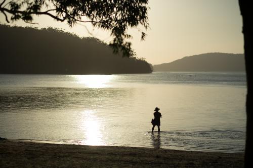 Lone fisherman at Sunset - Australian Stock Image