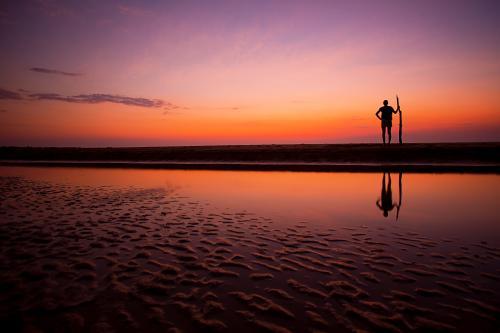 Lone tribal silhouette at sunset - Australian Stock Image