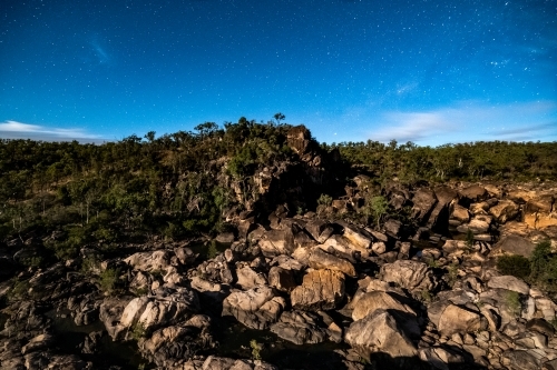 Long exposure nightfall shot of mountain hilltop rocks