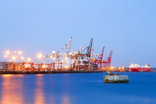 Cargo ship and cranes at a sea port. - Australian Stock Image