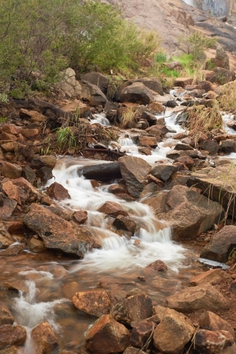 Long exposure of water flowing down rocky stream near Lesmurdie Falls, Perth, Western Australia